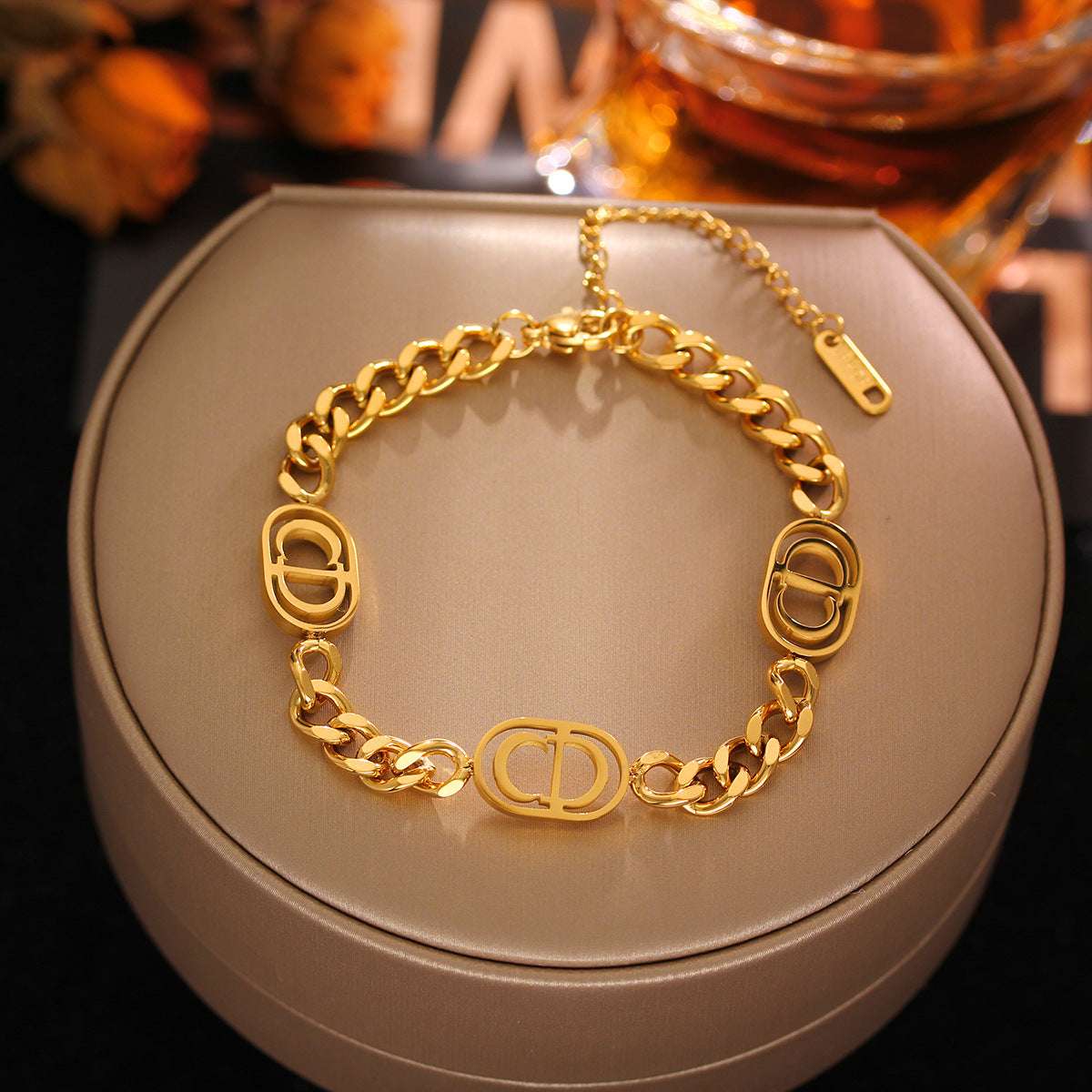 CD Cuban link chain bracelet resting on jewellery stand