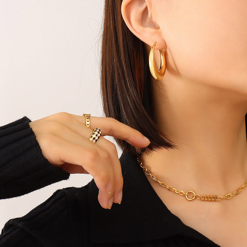 moon huggie earrings on right ear