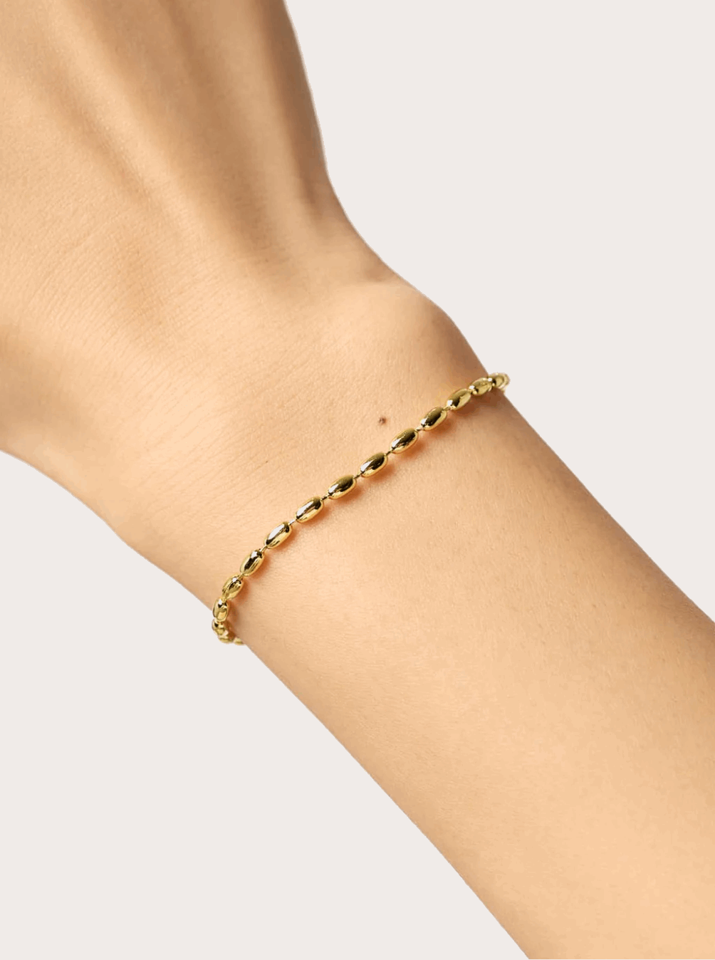 Crystal's Gold bead bracelet around girls wrist