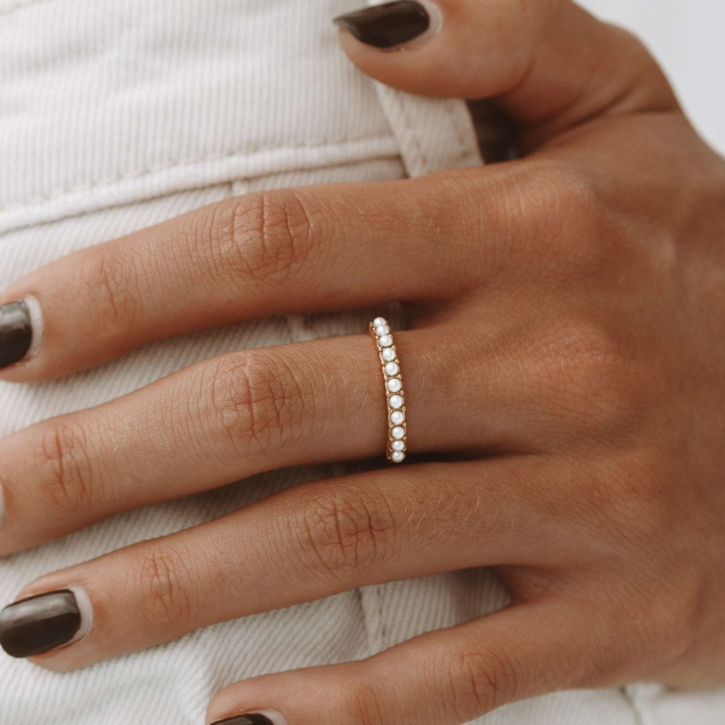 Pearl ring on girls middle finger