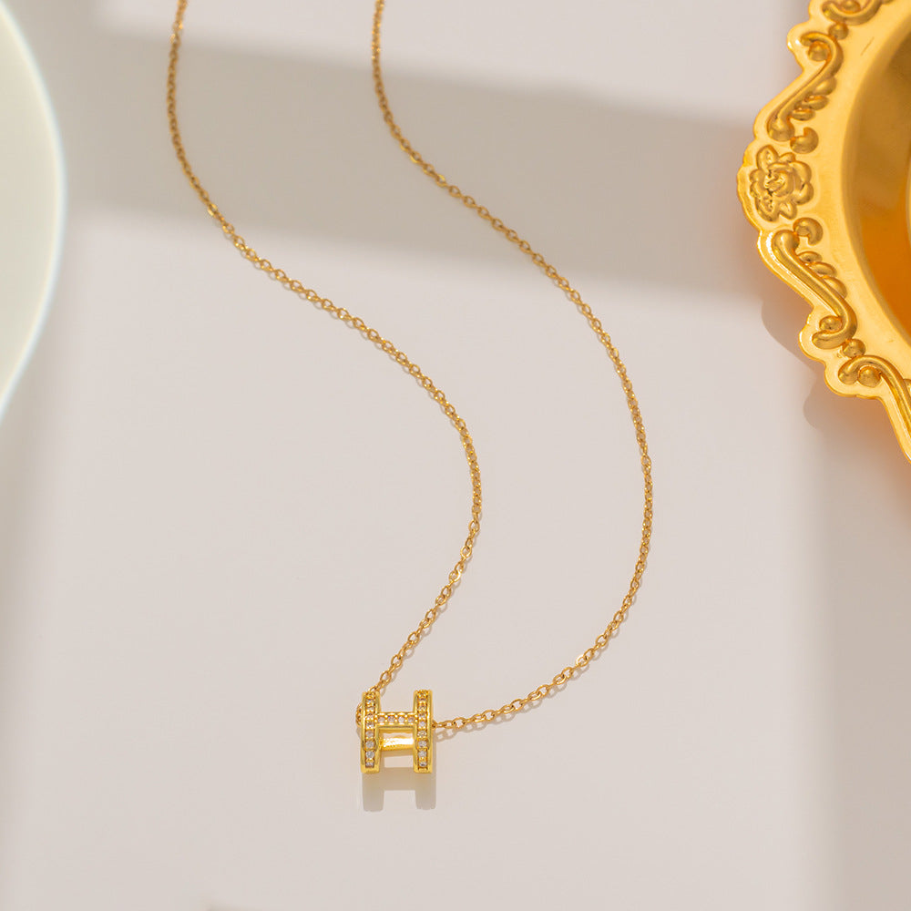 Gold H Necklace - Letter H Necklace, on surface