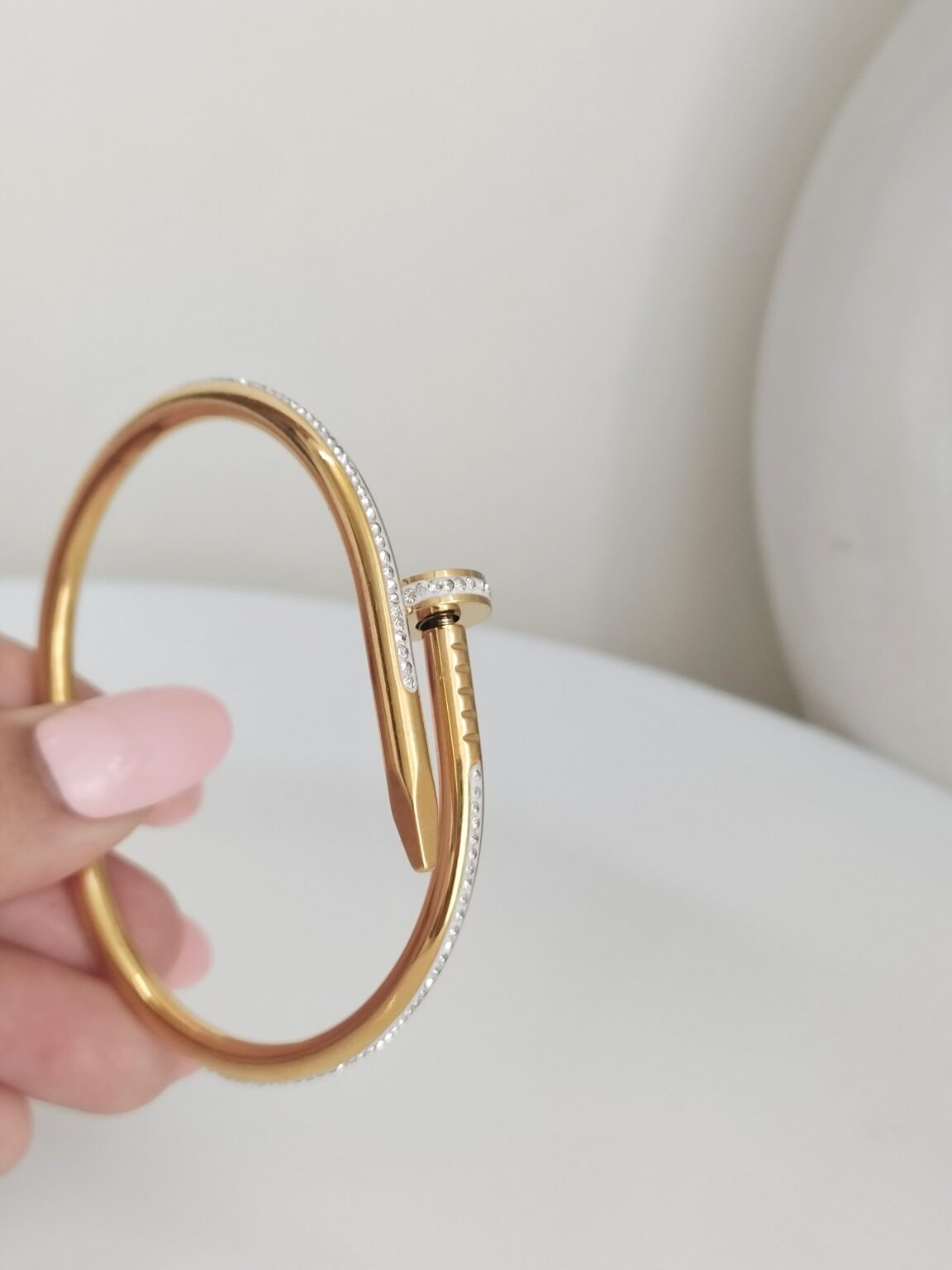 Gold Nail Bracelet with Crystals in girls hand