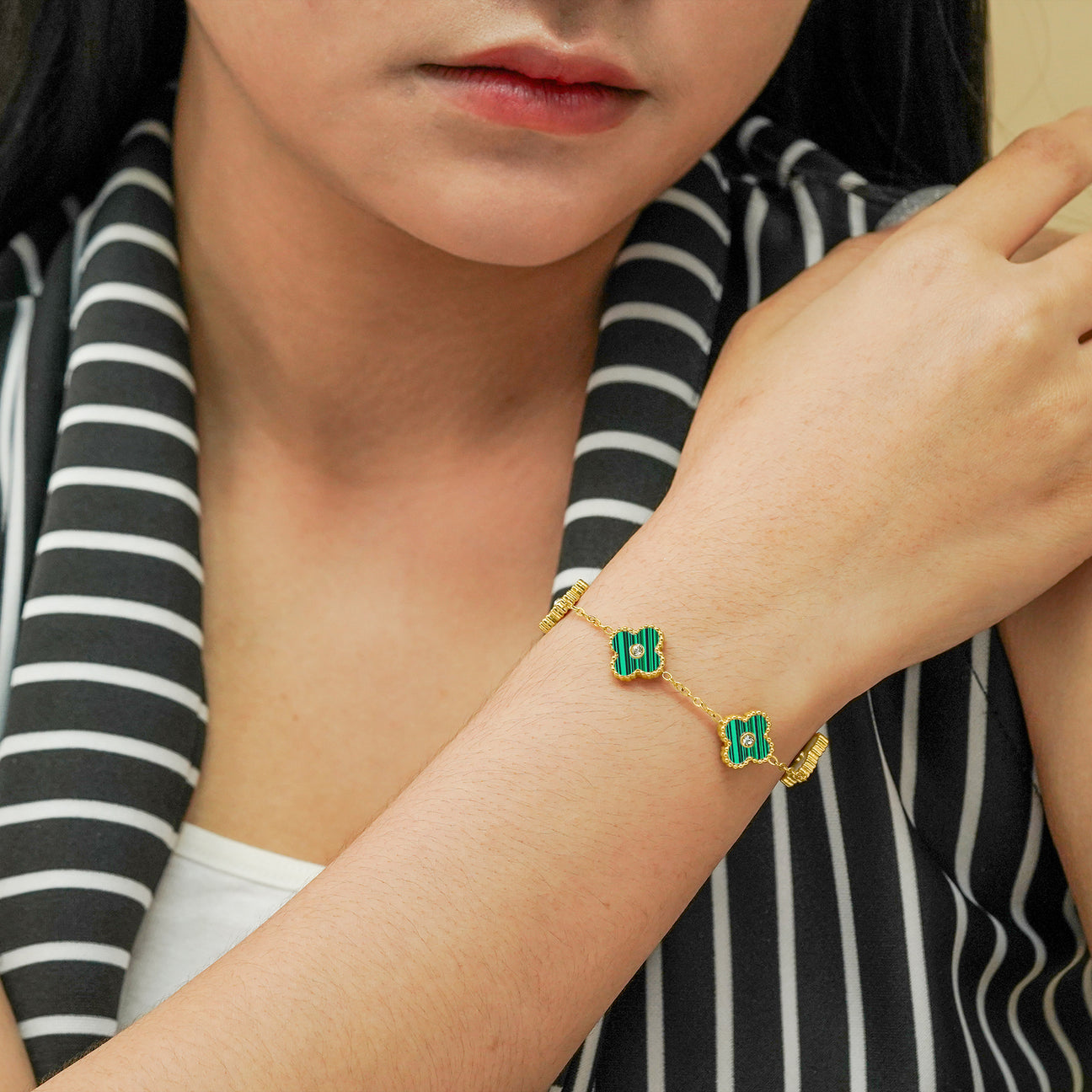 Green Four Leaf Clover Bracelet around Girls Wrist zoomed out