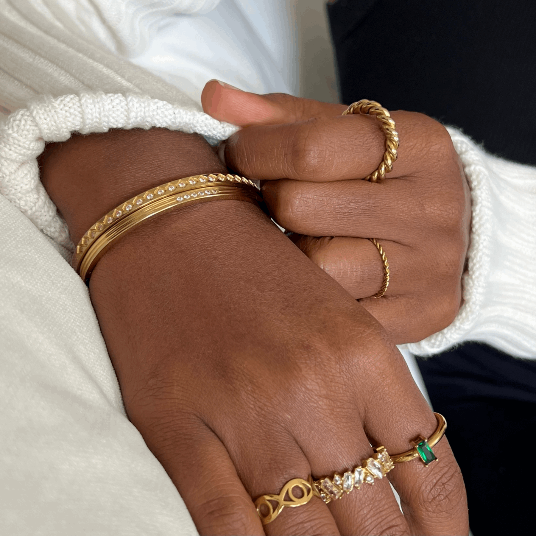 Mia's Gold Crystal Bracelet, appears with other rings and bracelets