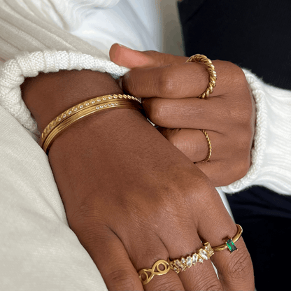 Mia's Gold Crystal Bracelet, appears with other rings and bracelets