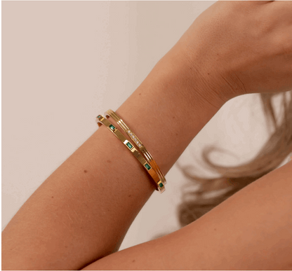 Mia's Gold Crystal Bracelet, next to emerald bracelet