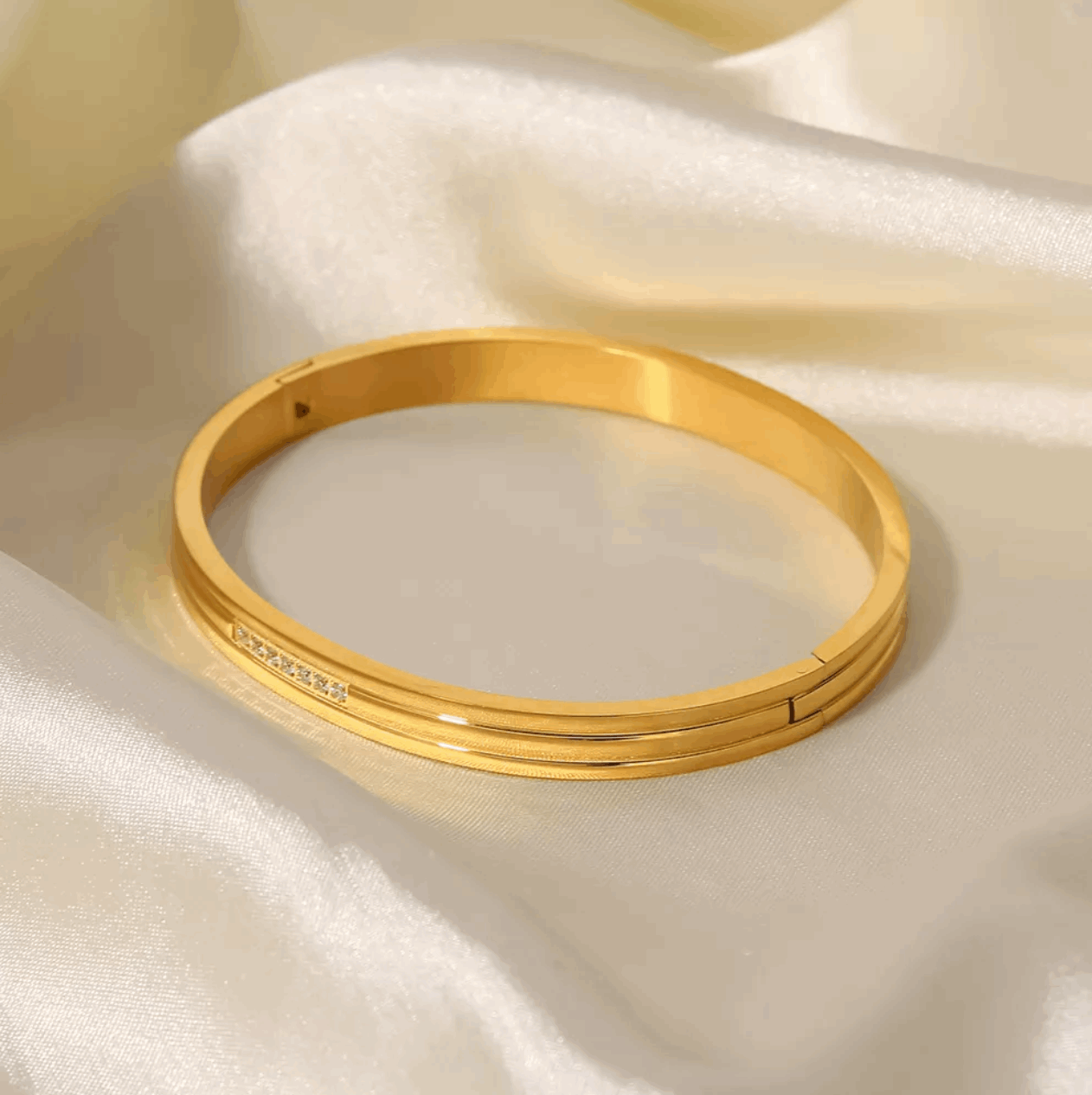 Mia's Gold Crystal Bracelet, resting on satin sheet