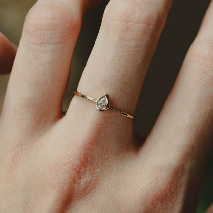 Pear Shaped Crystal Ring - Cubic Zirconia Gold Ring on middle finger, closeup